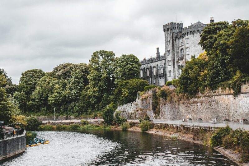 a castle on a hill by a river